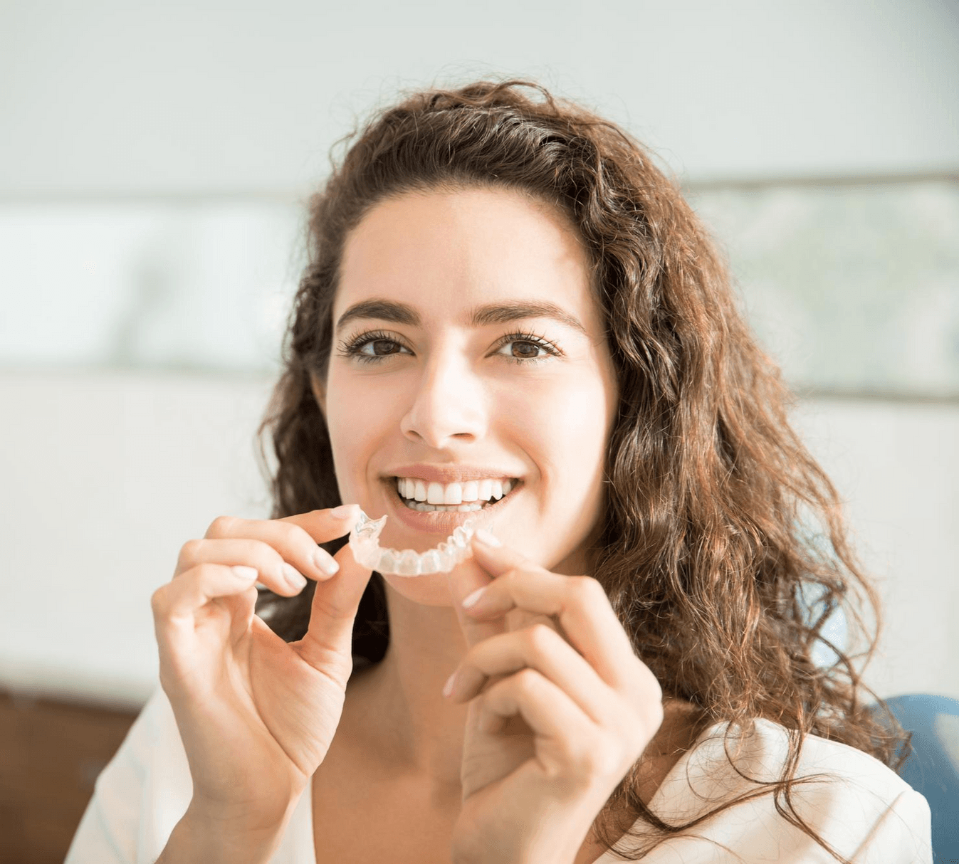 Patient placing a clear Invisalign aligner at Rancho Bernardo Dental Arts in San Diego